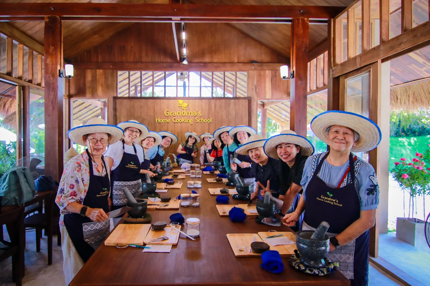 Travelers taking part in a Thai cooking class with mortars and fresh ingredients