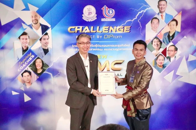 Phudit holding a certificate with another participant at an event