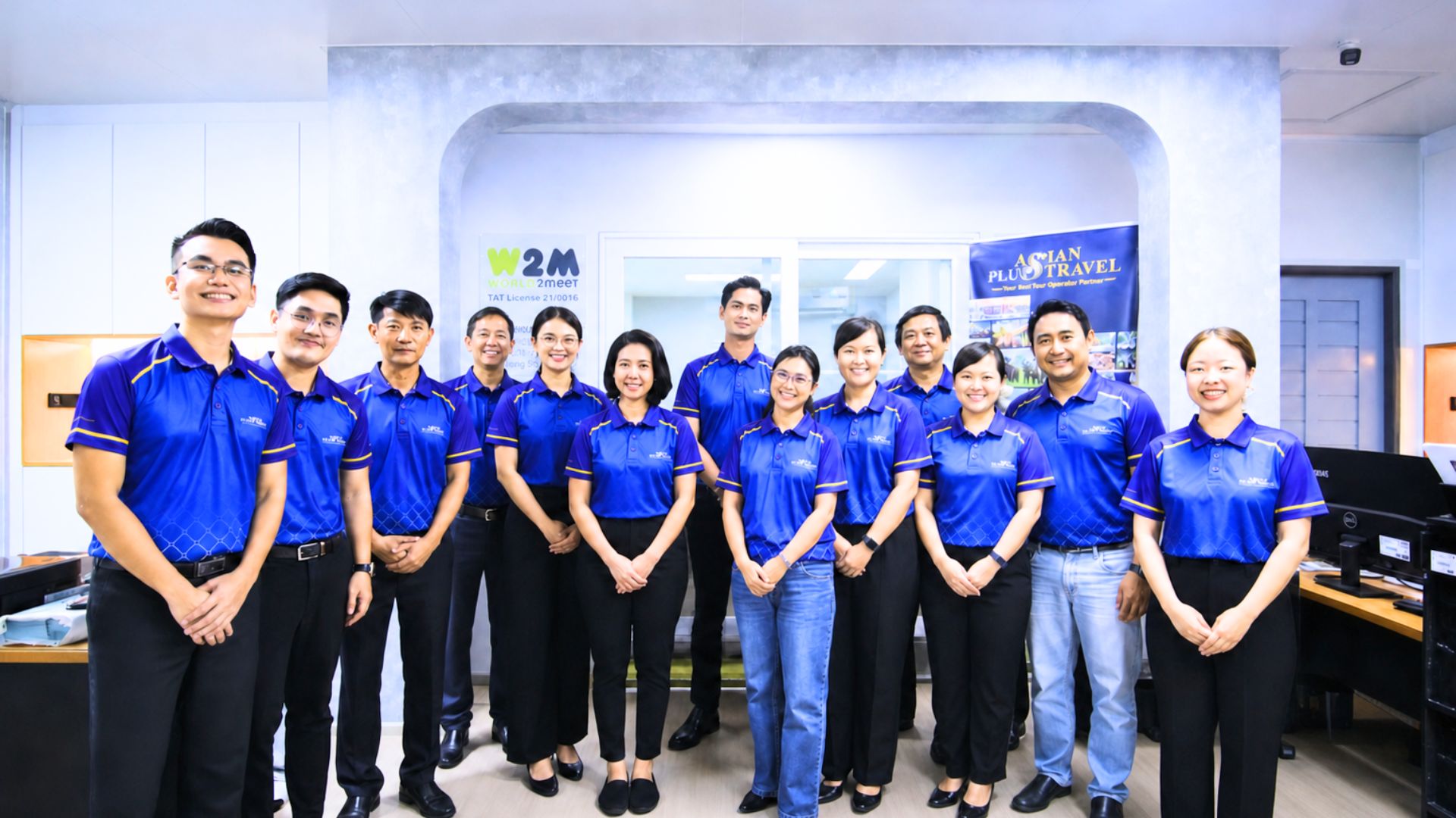 Asian Plus Travel team together in the office