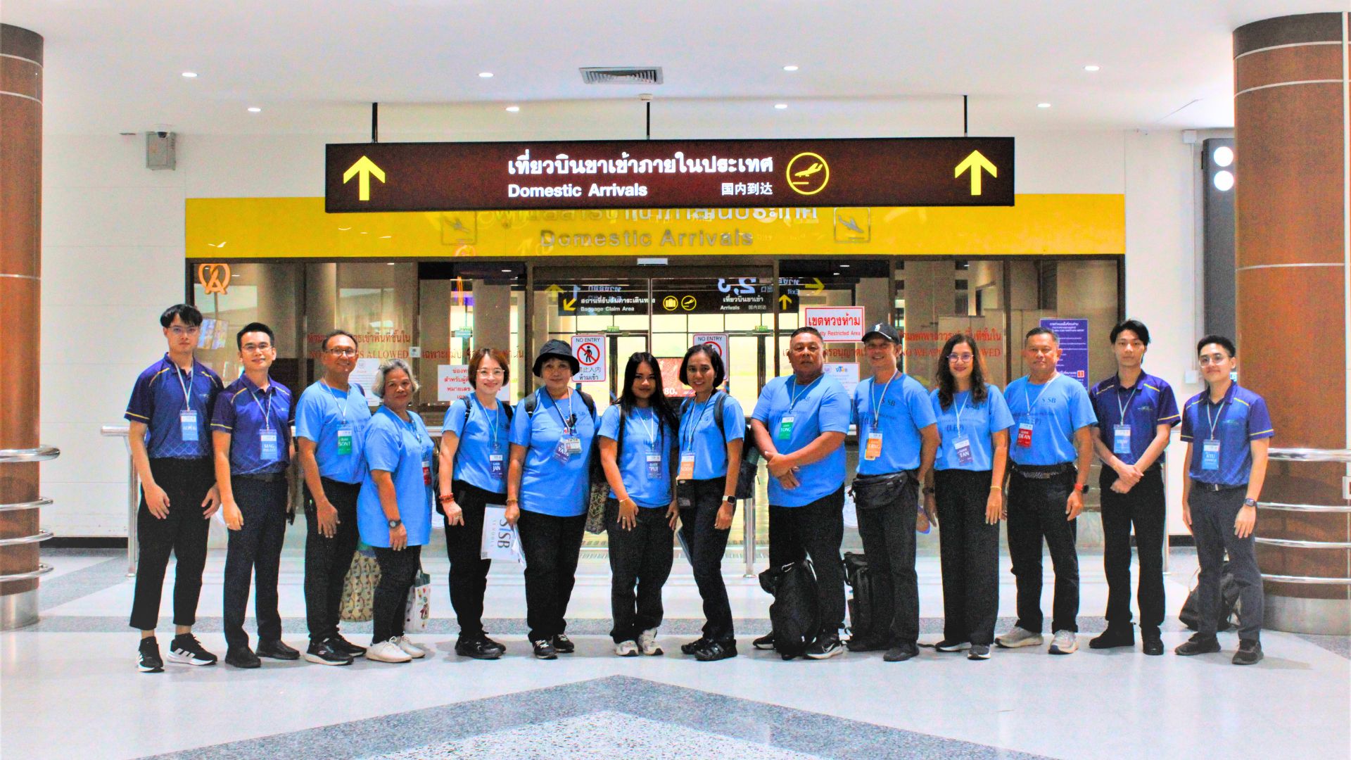 Asian Plus Travel team and a group at domestic airport arrivals