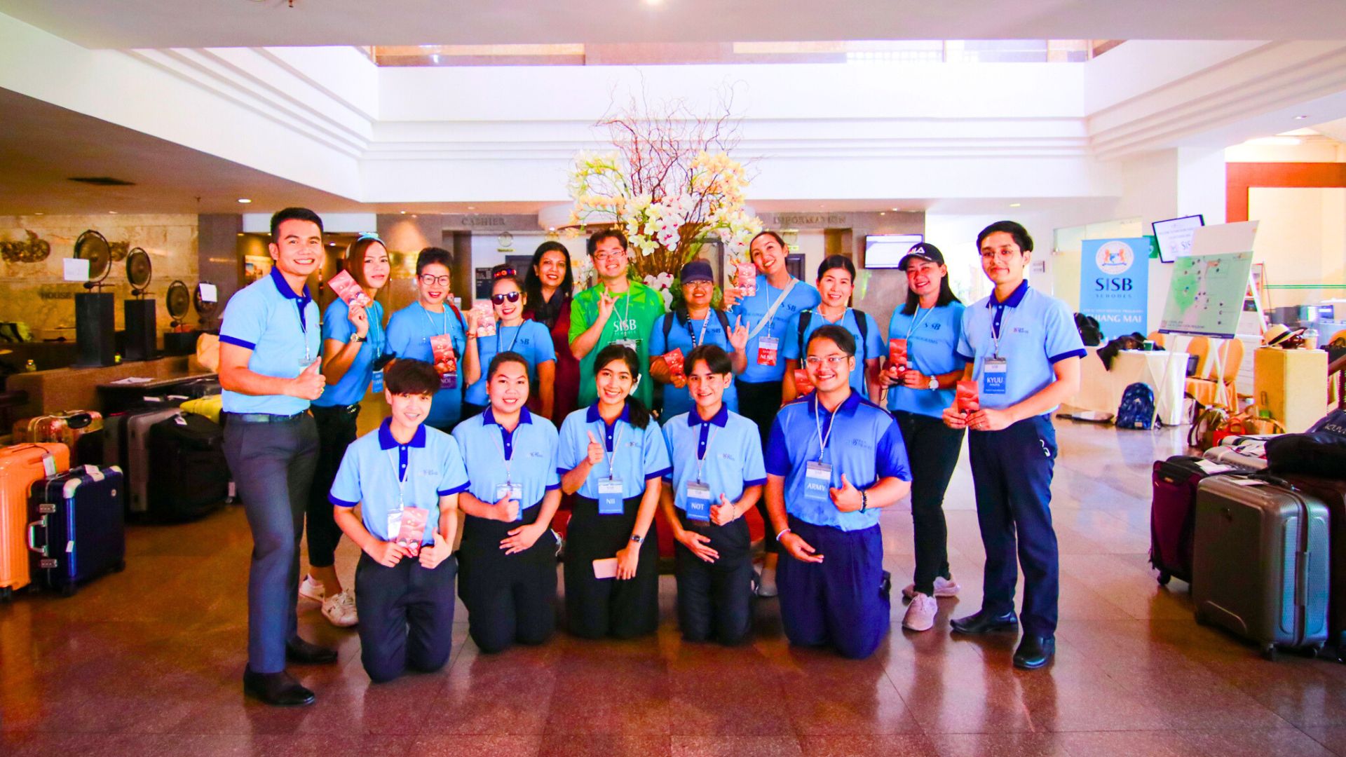 Team and group members gathered in a hotel lobby